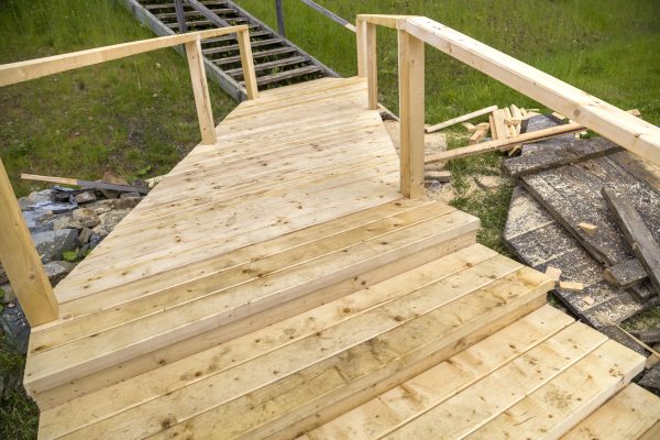 New wooden stairs outdoors. Carpenters work.